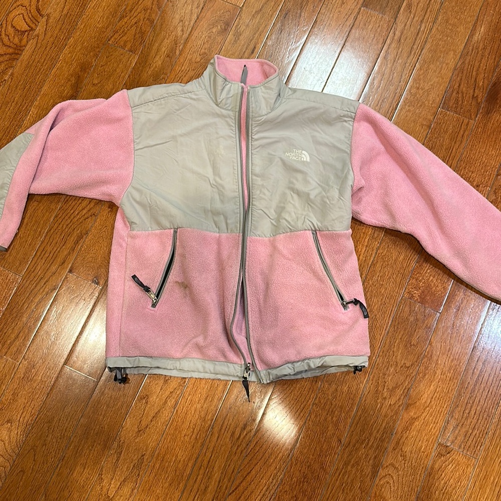 Pink and grey North Face light jacket.  Has some staining throughout jacket.